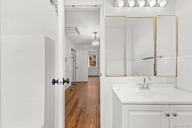a bathroom with a sink a mirror and shower