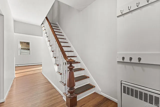 a view of an entryway with wooden floor
