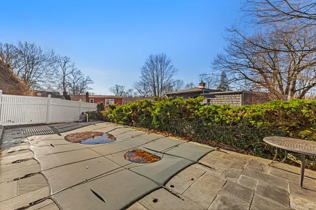 a view of backyard with seating space and trees