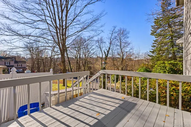 a view of balcony with wooden floor and fence