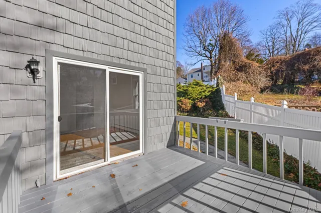 a view of a balcony with wooden floor