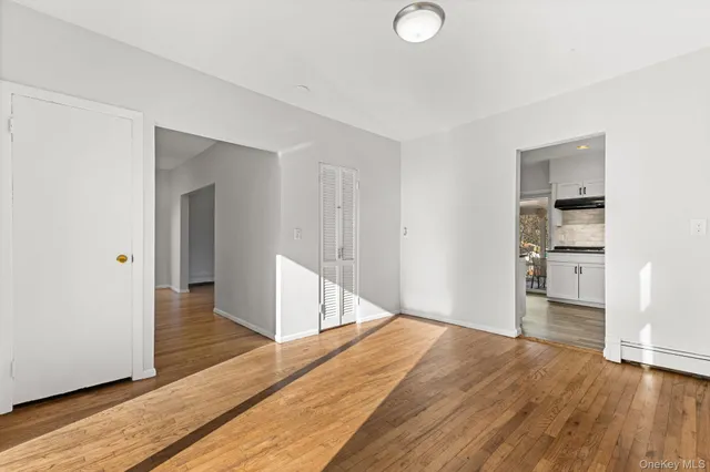 a view of empty room with wooden floor