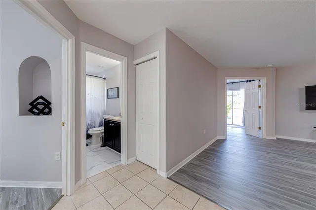 a large bed in a bedroom next to a window