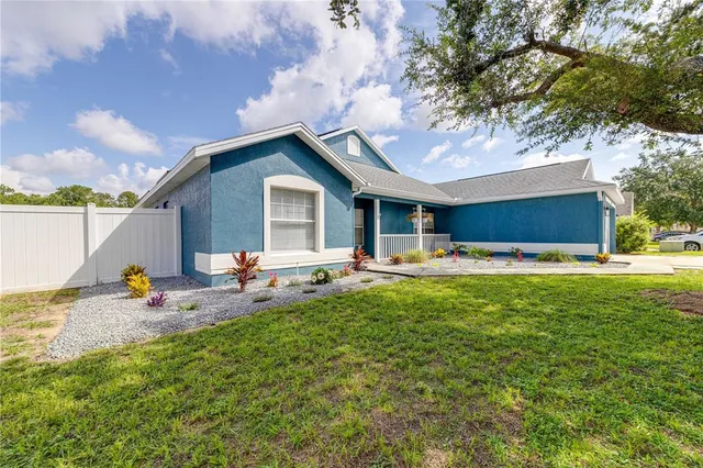 a backyard of a house with table and chairs