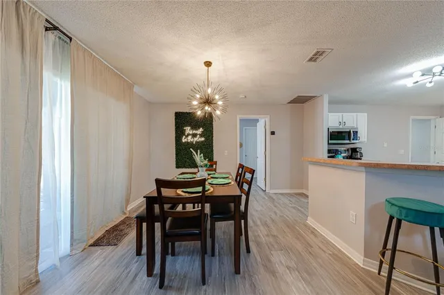 a kitchen with a refrigerator and a stove top oven