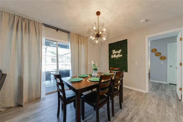 a kitchen with stainless steel appliances granite countertop a stove top oven a sink and dishwasher with white cabinets