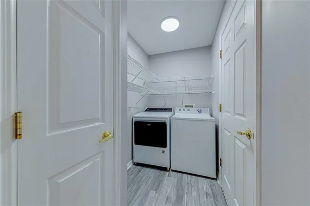 a kitchen with a granite countertop sink and a refrigerator