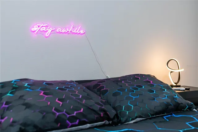 a bedroom with a bed and a painting on the wall