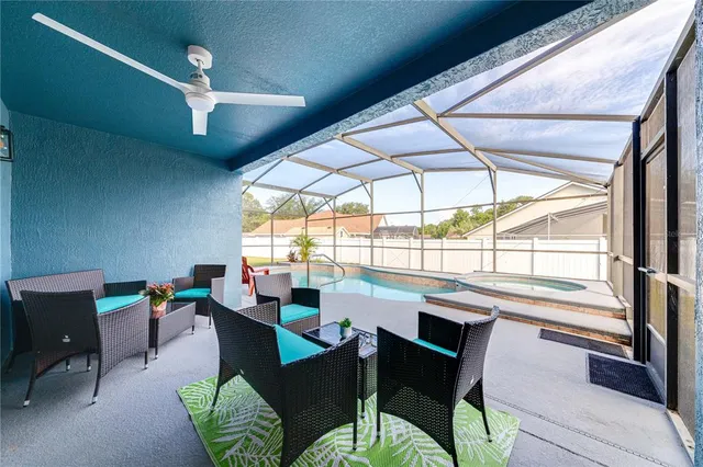 a dining room with furniture a rug and a large window