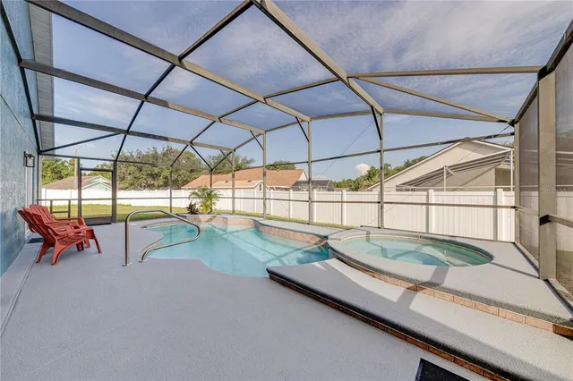 a view of a swimming pool with a lounge chair