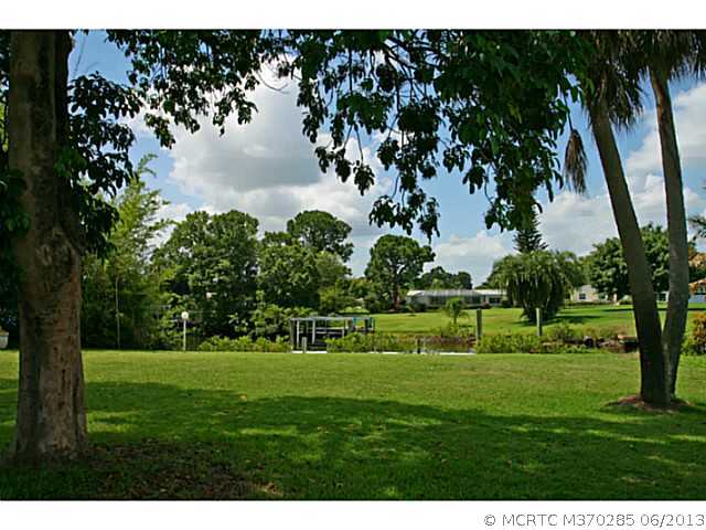 1144 Northwest Spruce Ridge Drive Stuart, FL 34994 - Photo 3 of 25 Exterior Front. Situated on approximately 1/2 acre on the canal