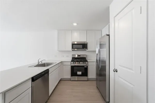 a kitchen with a sink and stainless steel appliances