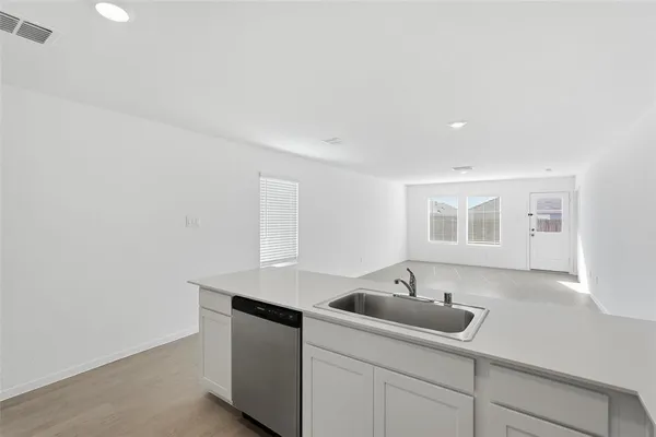 a kitchen with a sink and cabinets