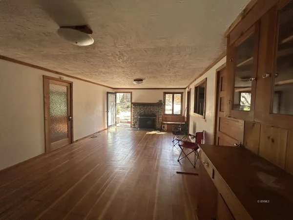 a very nice looking room with wooden floor and furniture
