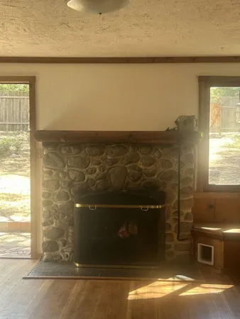 a living room with a bed and a window
