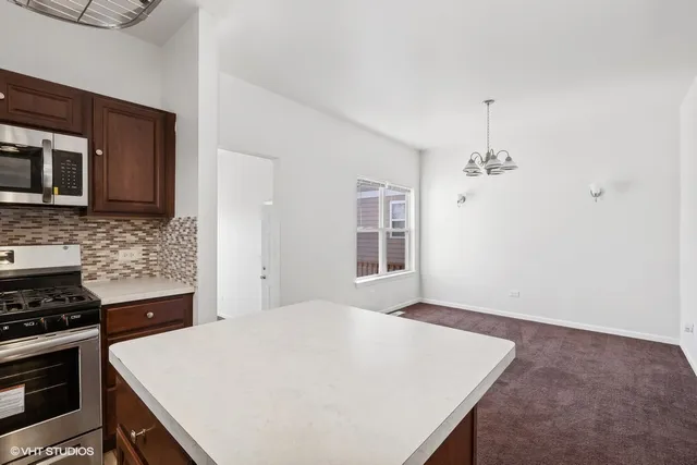a large white kitchen with stainless steel appliances