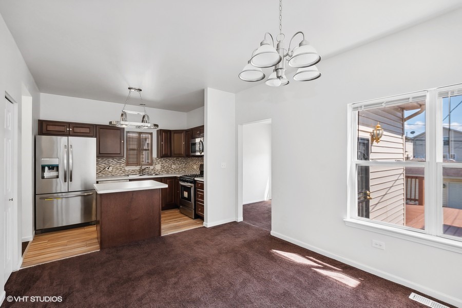 39 East 89th Street Chicago, IL 60619 - Photo 8 of 21 a kitchen with stainless steel appliances granite countertop a refrigerator a oven a sink dishwasher and white cabinets with wooden floor