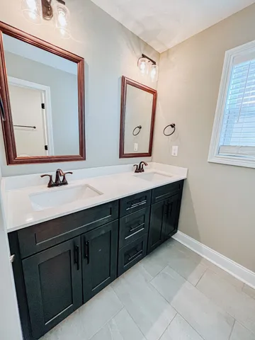 a bathroom with a sink vanity and mirror