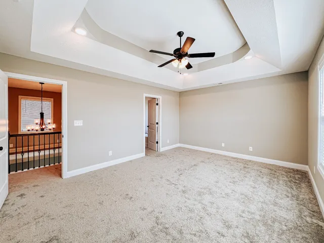 a view of a livingroom with a ceiling fan and entryway