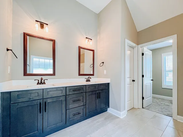 a bathroom with double sink and a mirror