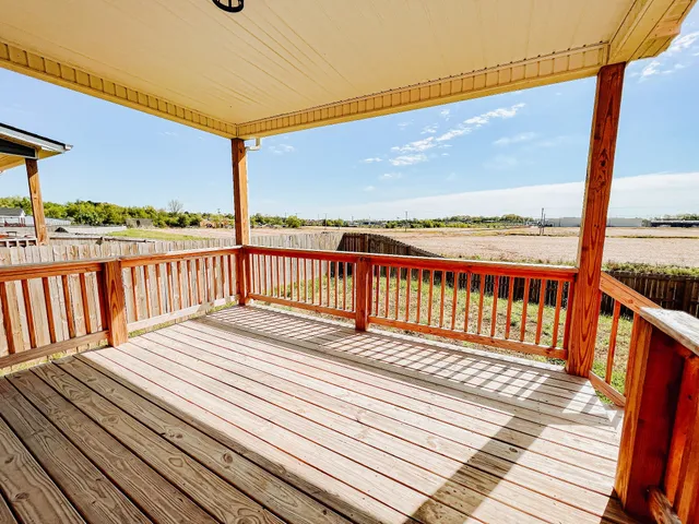 a view of a balcony with wooden floor