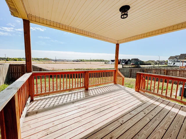 a view of balcony with wooden floor