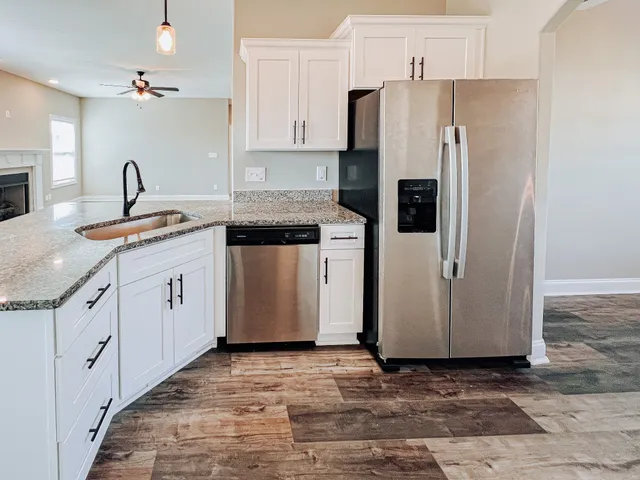 a kitchen with stainless steel appliances a refrigerator sink and cabinets