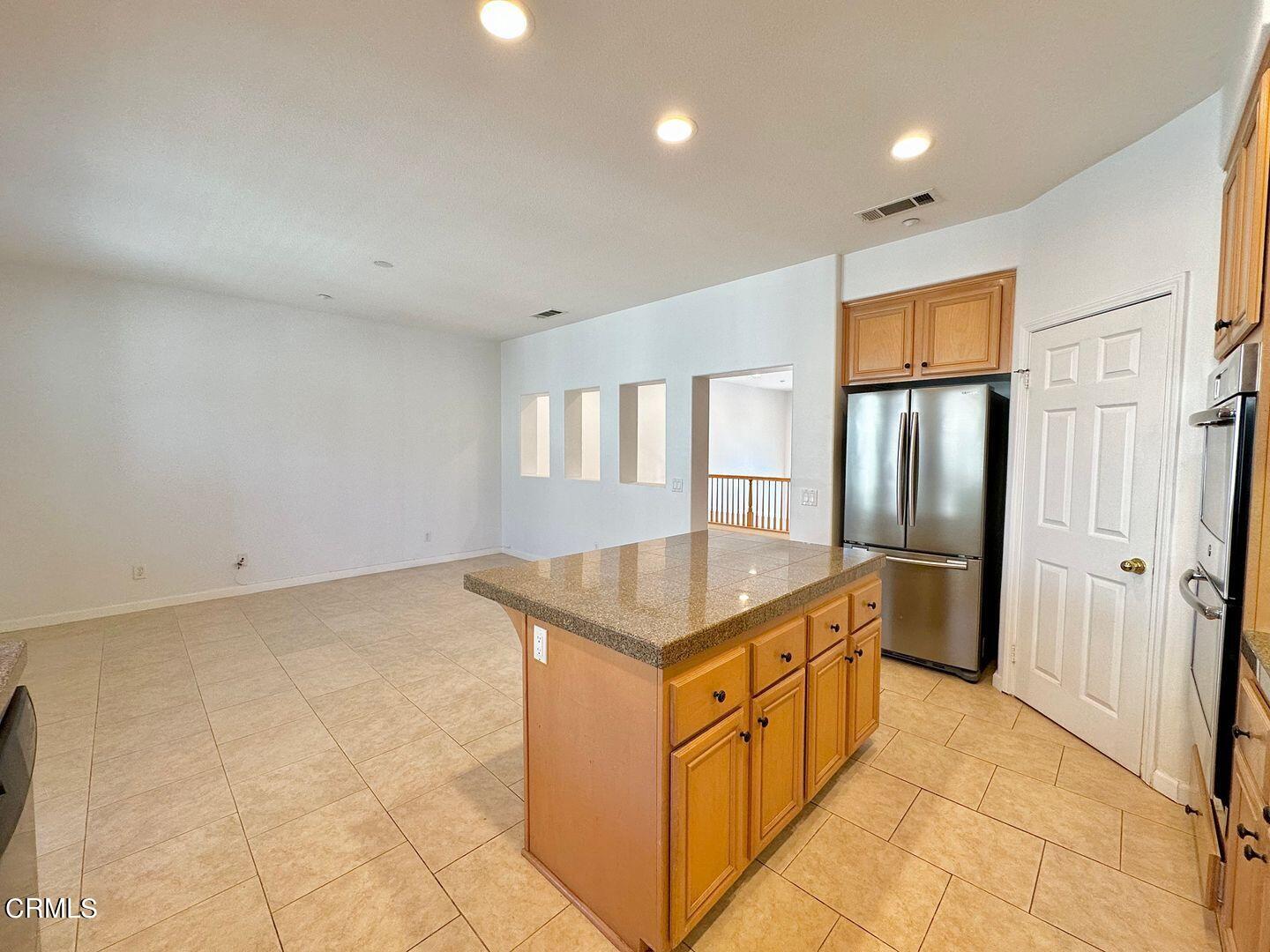 1202 Bayside Circle Oxnard, CA 93035 - Photo 17 of 48 a kitchen with stainless steel appliances granite countertop a stove a sink and a refrigerator
