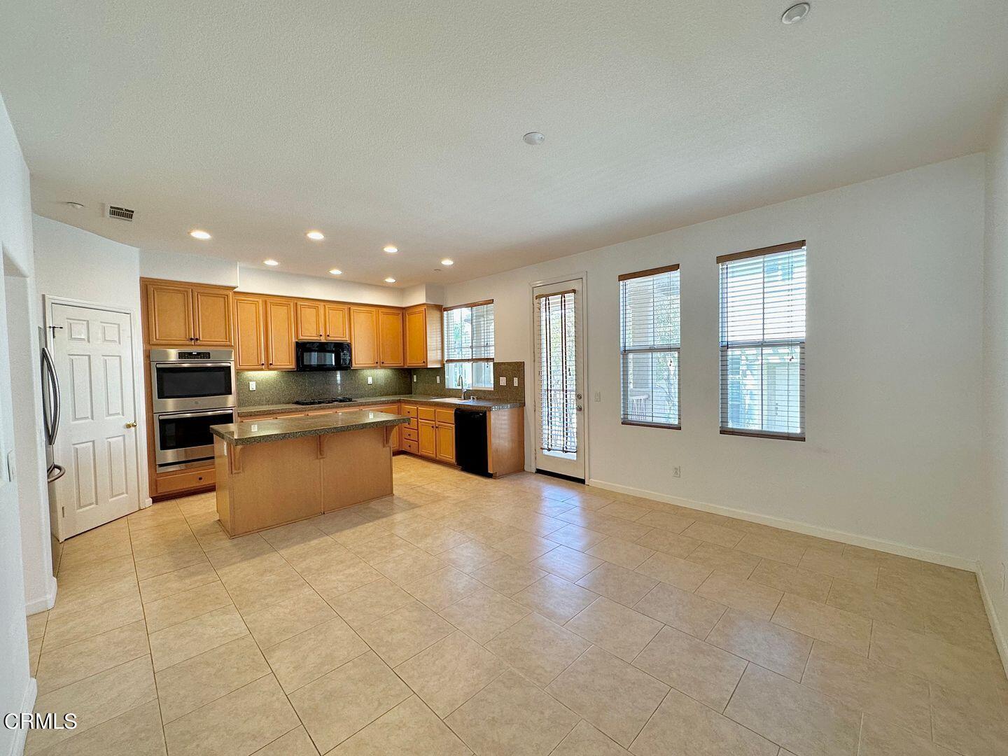 1202 Bayside Circle Oxnard, CA 93035 - Photo 20 of 48 a large kitchen with a large counter top stainless steel appliances and cabinets
