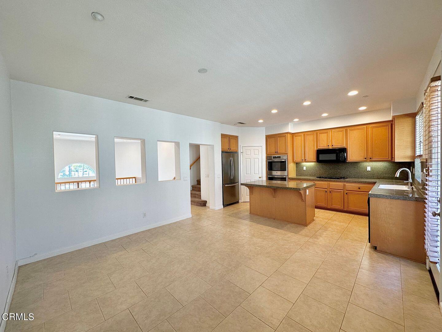 1202 Bayside Circle Oxnard, CA 93035 - Photo 21 of 48 a large living room with stainless steel appliances granite countertop a couch and a view of kitchen
