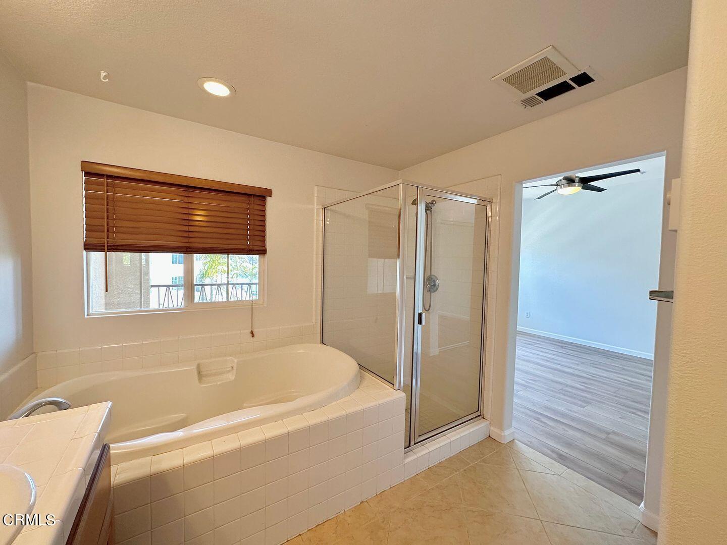 1202 Bayside Circle Oxnard, CA 93035 - Photo 30 of 48 a bathroom with a bathtub and a shower