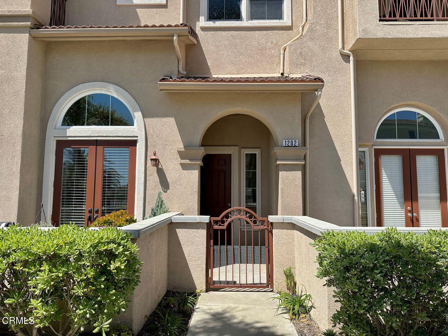 1202 Bayside Circle Oxnard, CA 93035 - Photo 3 of 48 a front view of a house with a garden