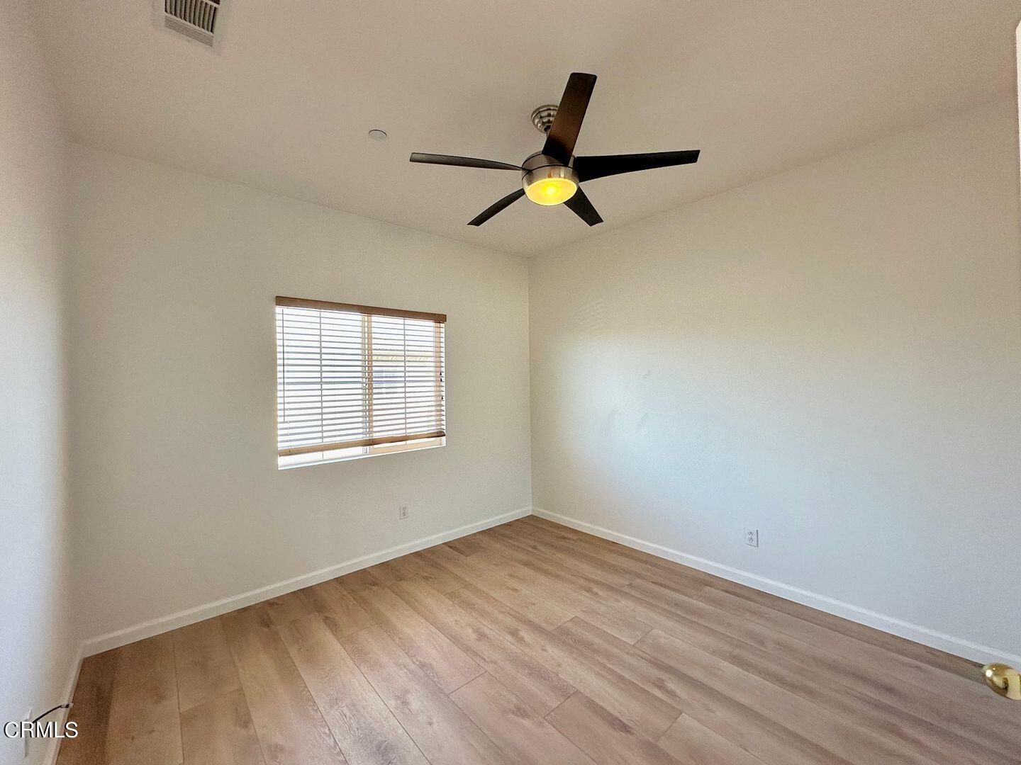 1202 Bayside Circle Oxnard, CA 93035 - Photo 40 of 48 wooden floor in an empty room with a window