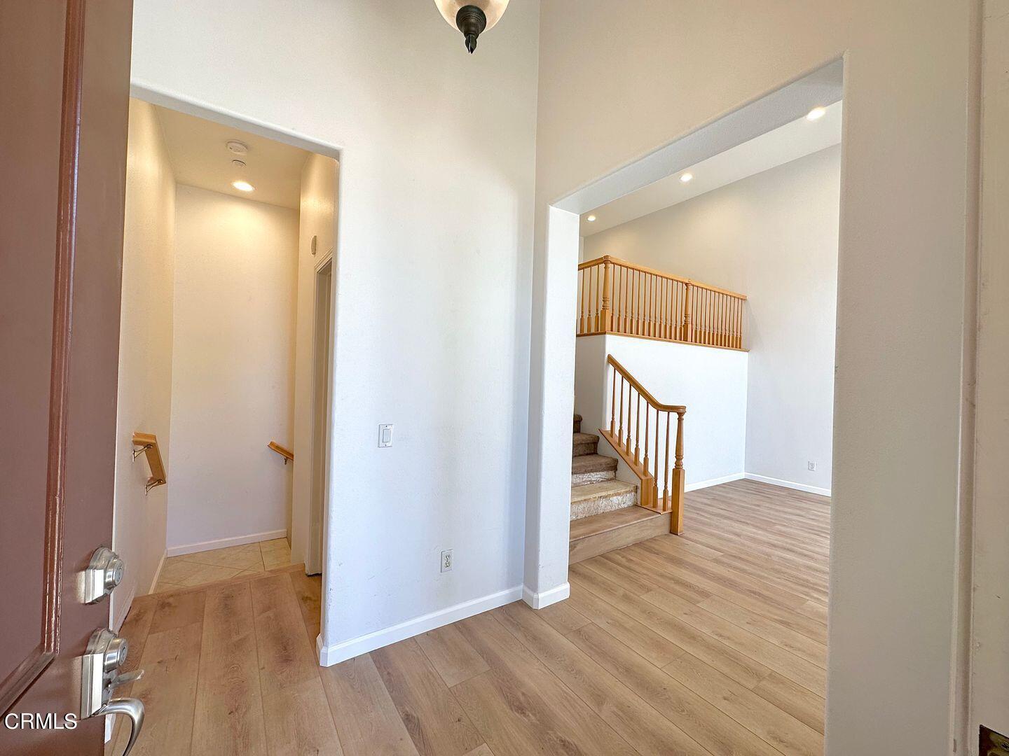 1202 Bayside Circle Oxnard, CA 93035 - Photo 4 of 48 a view of an empty room with wooden floor and a bathroom