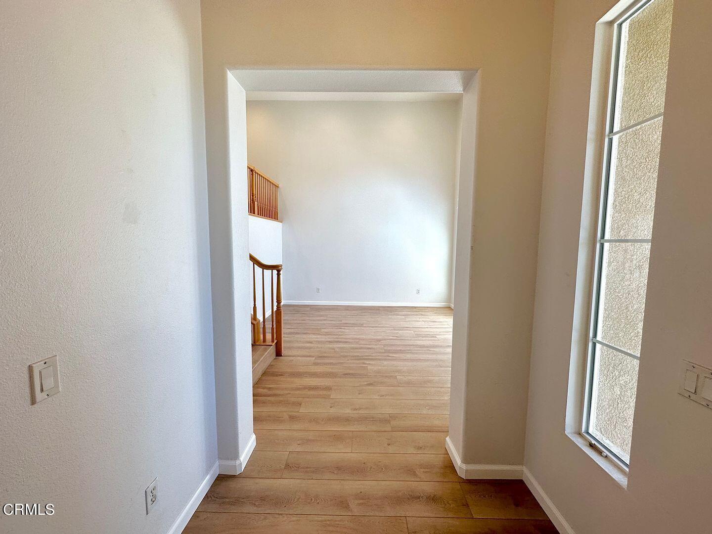 1202 Bayside Circle Oxnard, CA 93035 - Photo 5 of 48 a view of a hallway with wooden floor and staircase