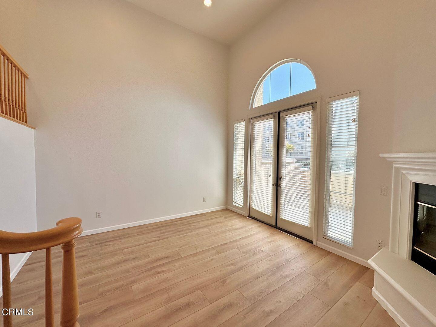 1202 Bayside Circle Oxnard, CA 93035 - Photo 6 of 48 a view of an empty room with wooden floor and a window