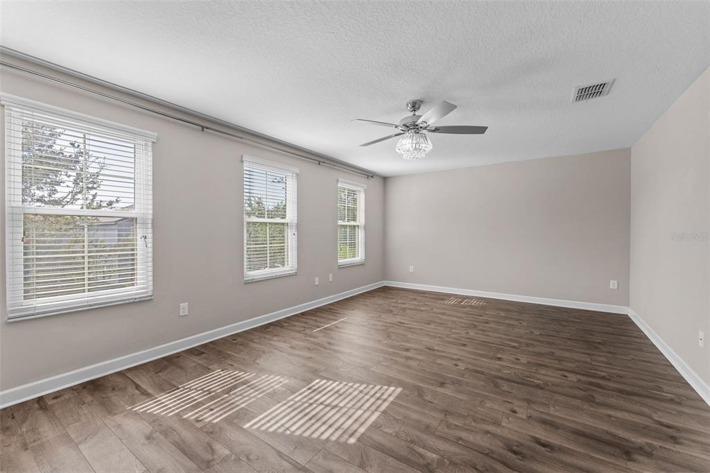 1040 Oliveto Verdi Court Brandon, FL 33511 - Photo 15 of 35 a view of an empty room with a window and wooden floor