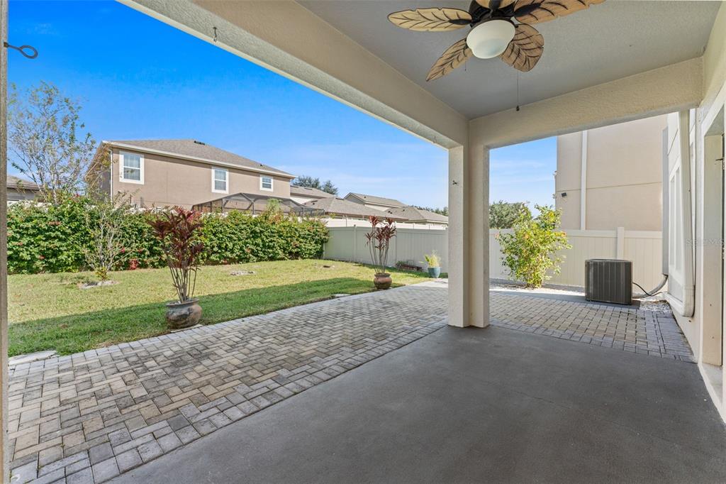 1040 Oliveto Verdi Court Brandon, FL 33511 - Photo 18 of 35 a view of a porch with a table and chairs and potted plants