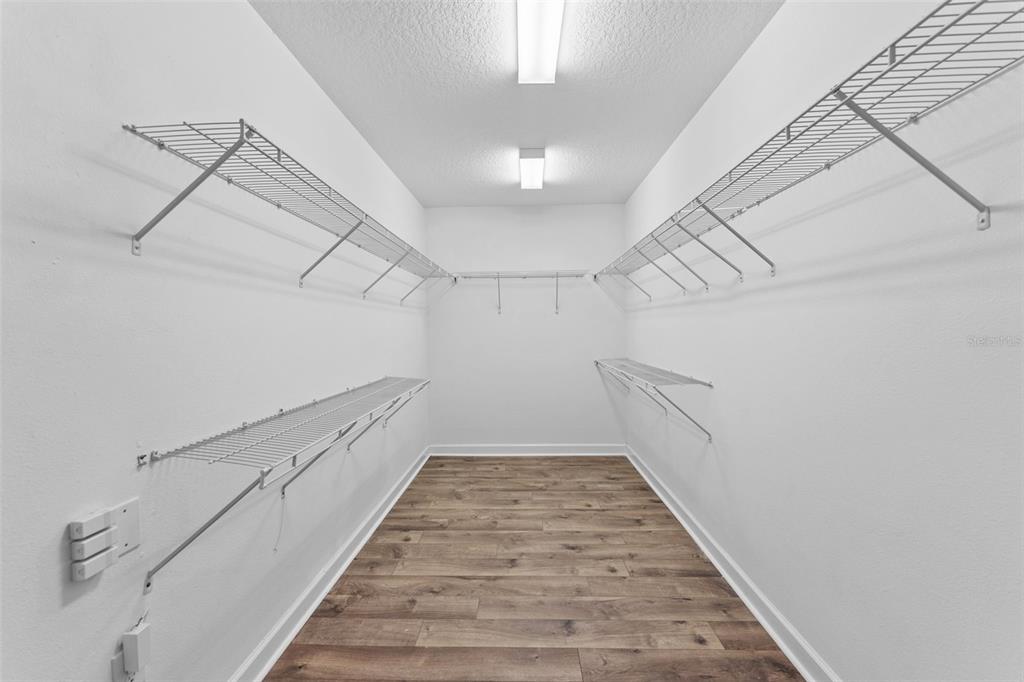 1040 Oliveto Verdi Court Brandon, FL 33511 - Photo 20 of 35 a view of a hallway with the white walls and wooden floor