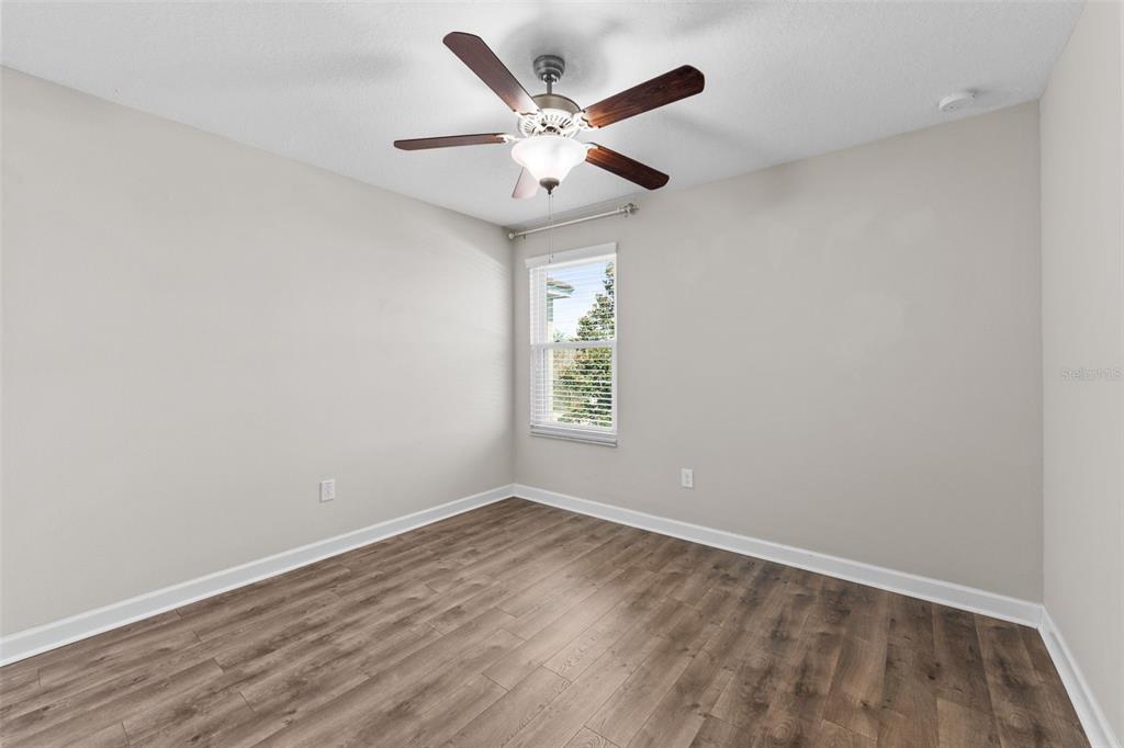 1040 Oliveto Verdi Court Brandon, FL 33511 - Photo 21 of 35 an empty room with a window and a ceiling fan