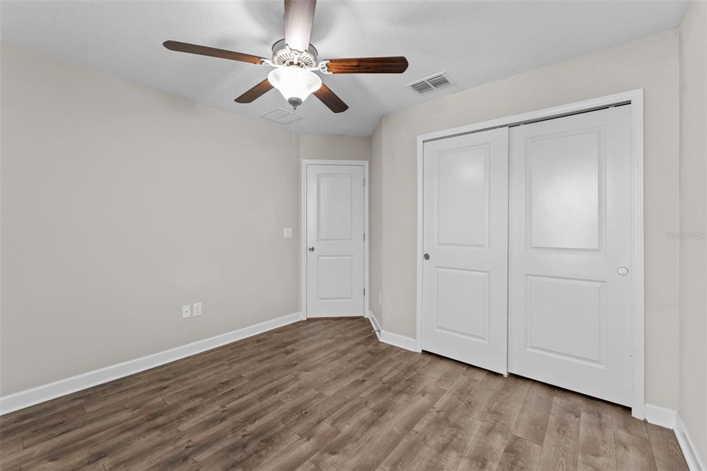 1040 Oliveto Verdi Court Brandon, FL 33511 - Photo 22 of 35 a view of an empty room with wooden floor
