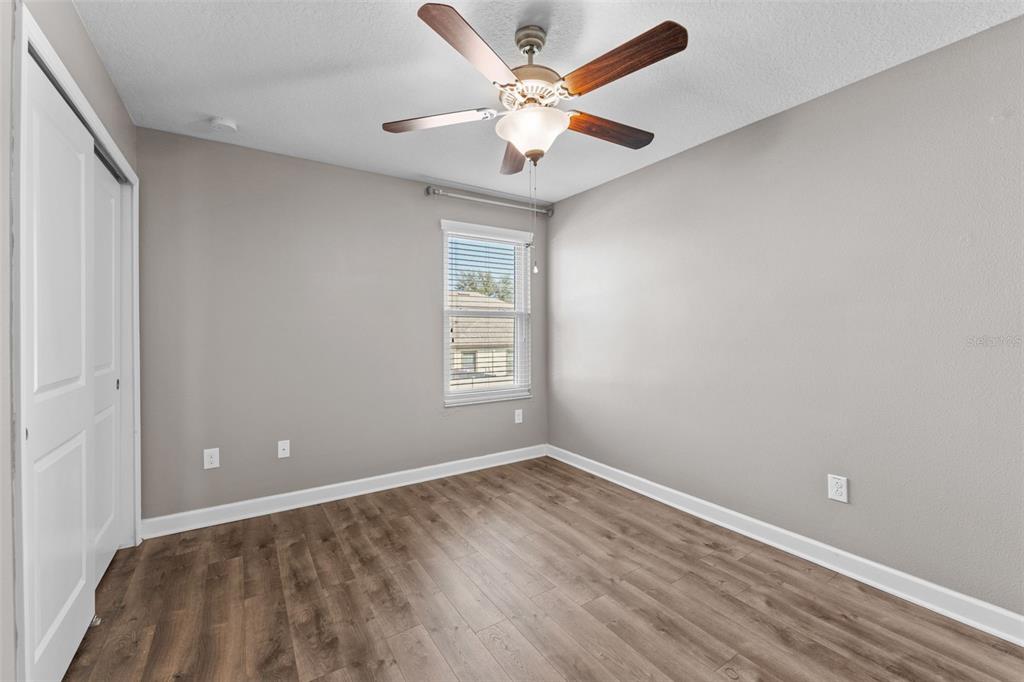 1040 Oliveto Verdi Court Brandon, FL 33511 - Photo 24 of 35 wooden floor in an empty room with a window