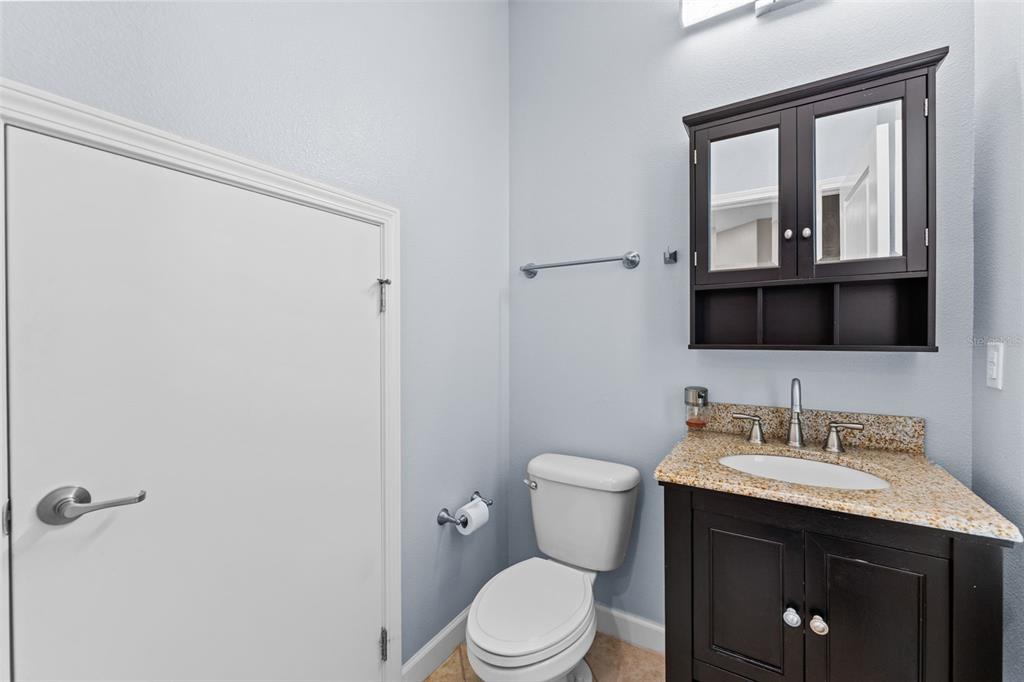1040 Oliveto Verdi Court Brandon, FL 33511 - Photo 26 of 35 a bathroom with a sink vanity mirror and toilet