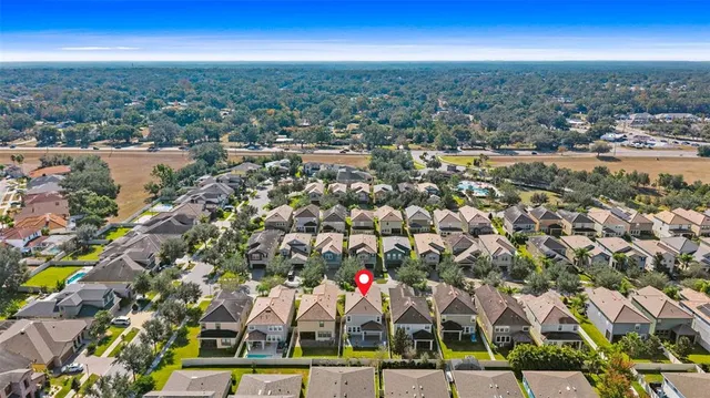an aerial view of residential houses with city view