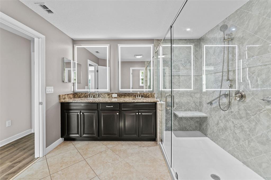 1040 Oliveto Verdi Court Brandon, FL 33511 - Photo 5 of 35 a bathroom with a tub a sink and glass door