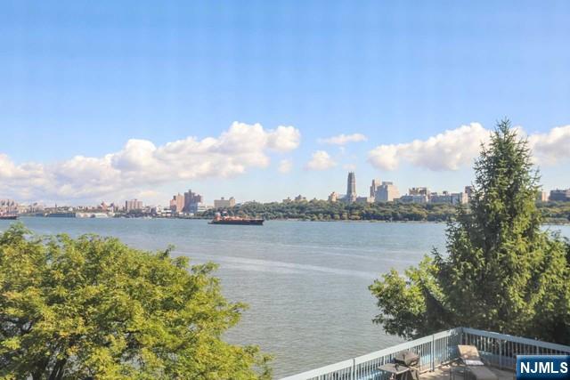 403 Nelson Court, Unit 403A Edgewater, NJ 07020 - Photo 14 of 18 a view of a lake with houses in the back