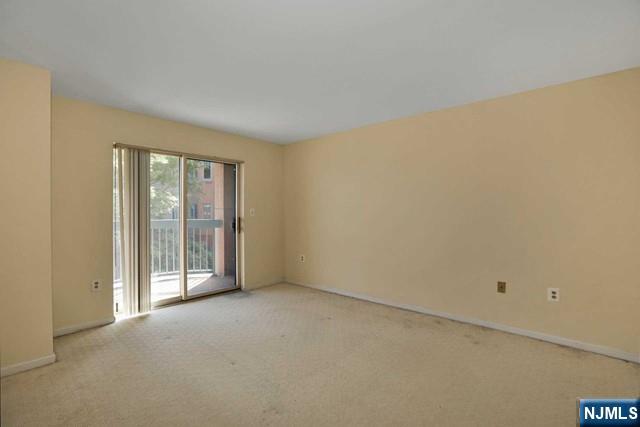 403 Nelson Court, Unit 403A Edgewater, NJ 07020 - Photo 7 of 18 a view of an empty room with glass door