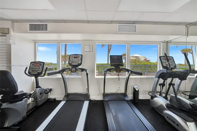 a view of gym equipment with wooden floor