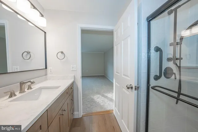 a bathroom with a glass shower door