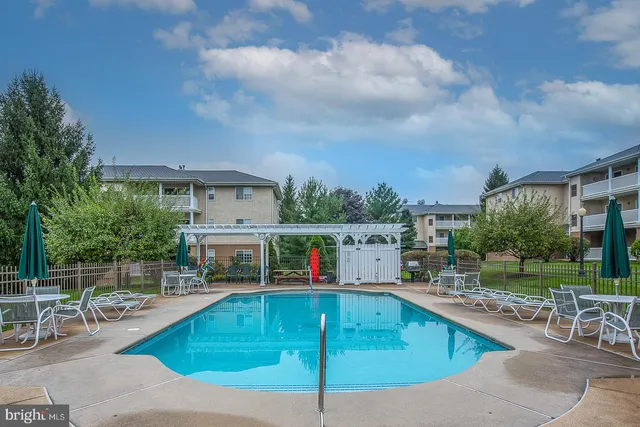 a view of a swimming pool with a yard